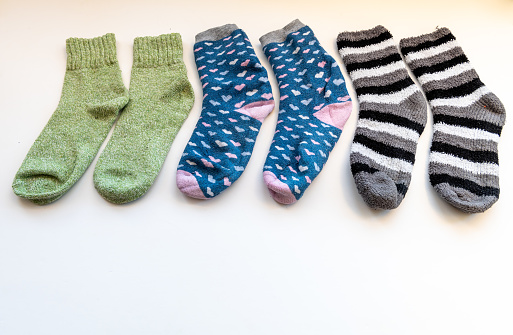 Various thick Winter socks arranged in a row isolated in white.