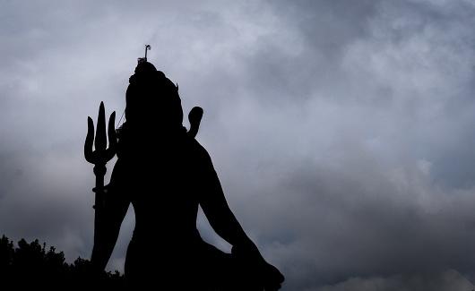 backlit isolated shot of hindu god shiva with dramatic background