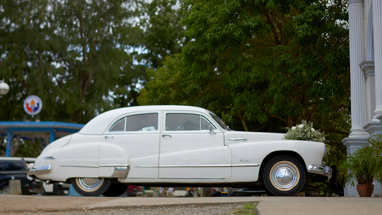 Poblacion, Panglao, Bohol, Philippines, 12.08.2023, retro car  Buick Eight , white, in the wedding ceremony