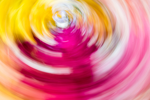 A vivid close-up shot of a multicolored spiral twirling in the air, creating an eye-catching motion blur effect