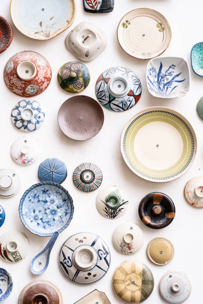 istock Ceramic pottery collection decorating wall. Vintage plates craft products display. 1840097464