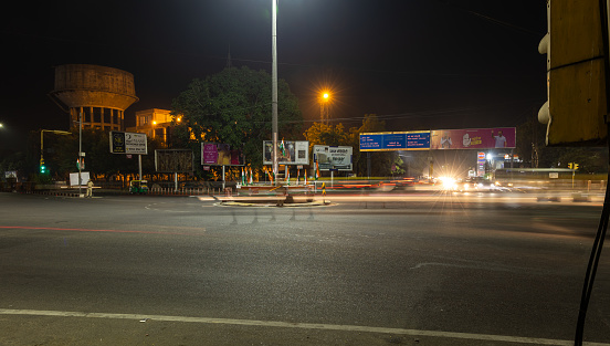 city street traffic long exposure shot with blurred light trails with at traffic control signal image is taken at sardar market ghantaGhar jodhpur rajasthan india on Nov 06 2023.