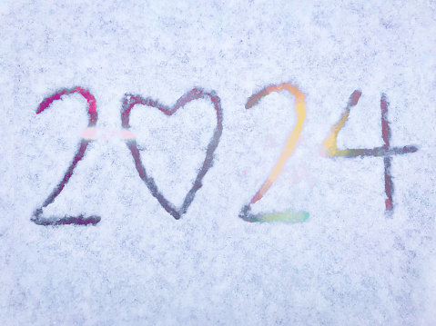 New Year 2024 handwriting with love concepts on ground covered fresh snow