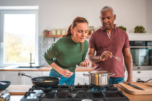 istock Modern Mature Couple Cooking Together 1840106012