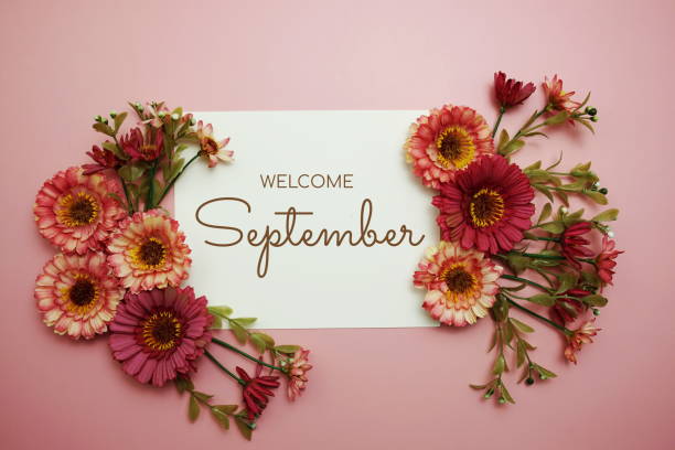 istock Welcome September typography text with flowers on pink background 1840117658