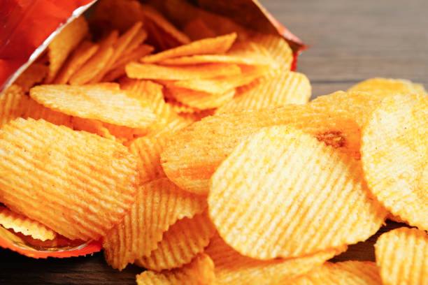 istock Potato chips in open bag, delicious BBQ seasoning spicy for crips, thin slice deep fried snack fast food. 1840119499