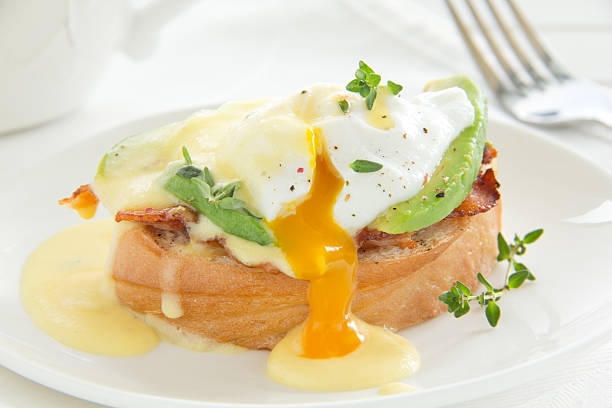 istock Breakfast. Poached egg with hollandaise sauce, bacon and avocado. 184011968