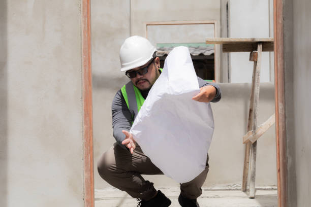 istock Asian construction project foreman with beard inspects construction site holding blueprint paperwork, engineering architect contractor man worker wearing safety helmet working in workplace outdoor 1840136707