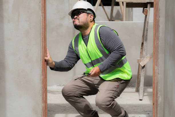 istock Asian young overweight engineering foreman worker wearing safety white helmet accidentally slipped unfinished door on construction site backache, unhealthy foreman at work, accident insurance concept 1840137517
