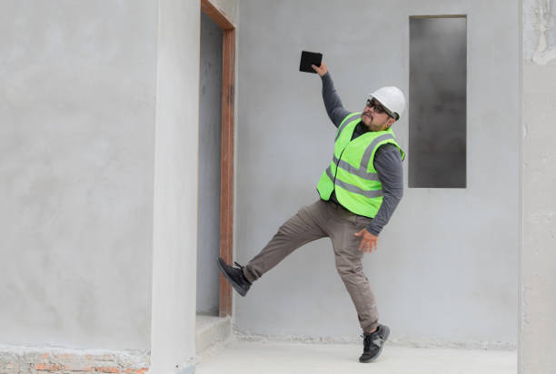 istock Asian managers, foremen, or engineer slip on unfinished cement in site accident in workplace, construction supervisor wearing white helmet hold tablet fall to the floor, insurance and safety concept 1840137838