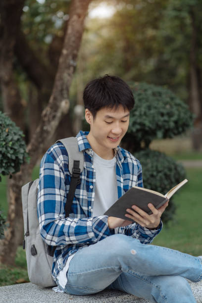 istock Students Reading Books In University Campus, summer vacation. 1840138358