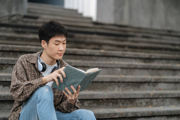 istock Students Reading Books In University Campus, summer vacation. 1840138881