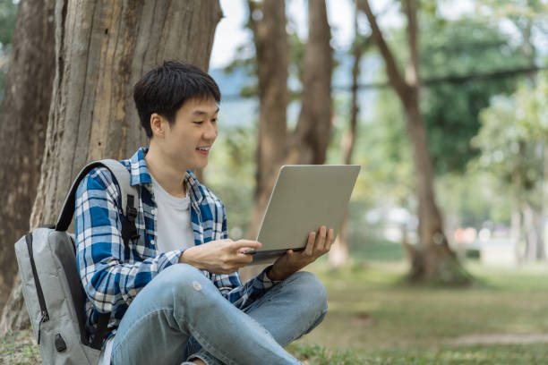 istock Asian students joining study book, smiling with laptop computer tablet at high school university, college, vacation, summer vacation. 1840138886