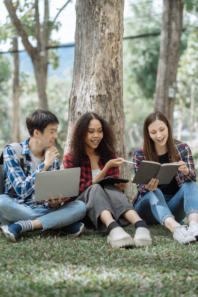 istock Education knowledge and university concept - group of students reading and preparing for exams on holiday. 1840138896