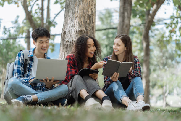 istock Education knowledge and university concept - group of students reading and preparing for exams on holiday. 1840138924