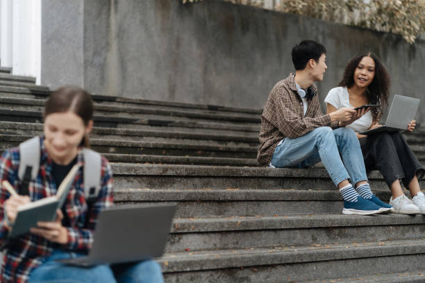 istock Education knowledge and university concept - group of students reading and preparing for exams on holiday. 1840139131
