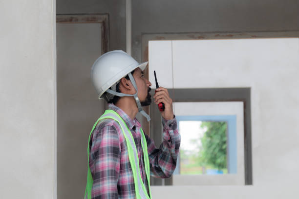 istock Asian or Indian architect foreman male working control communicate with builder using walkie-talkie radio on construction site real estate small business projects, contractor man wearing safety vest 1840139463
