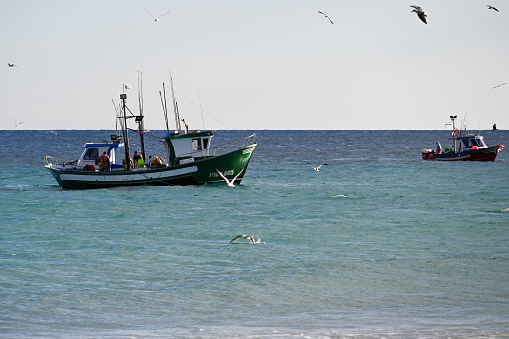 Jandia, Fuerteventura, Spain, November 25, 2023 - Fishing boats near Playa Pariso off the east coast of the Canary Island of Fuerteventura, Spain.