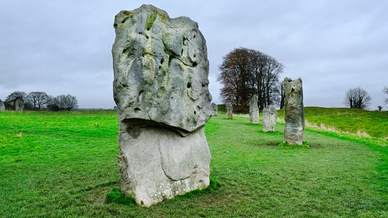 The world famous prehistoric landmark and UNESCO World Heritage Site on Salisbury Plain, Wiltshire, England. A beautiful blue sky with fluffy clouds provides copy space above while bright green grasses below grab the viewer's attention.