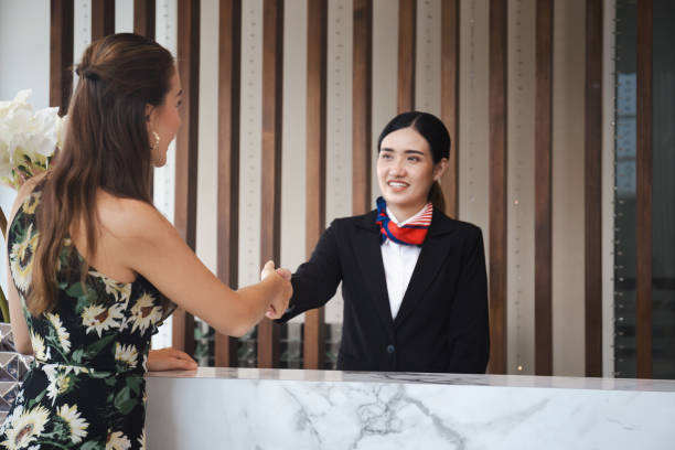istock Receptionist and guest making handshake at hotel reception, Receptionist shaking hands with young female travelers at hotel counter 1840174160