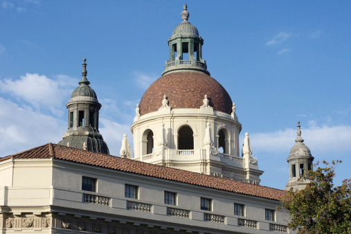 Pasadena City Hall is a fine example of the California Mediterranean style. It was opened in 1927, and is listed on the National Register of Historic Places. This image shows the main dome over the west entrance, and the two small towers at the north and south corners of the rectangular edifice. The photo was taken in daylight with a nice blue sky and a few clouds.