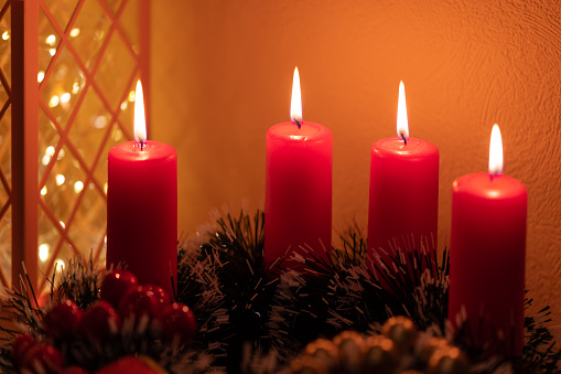 Three red candles on gray background, Christmas decoration. Advent mood.