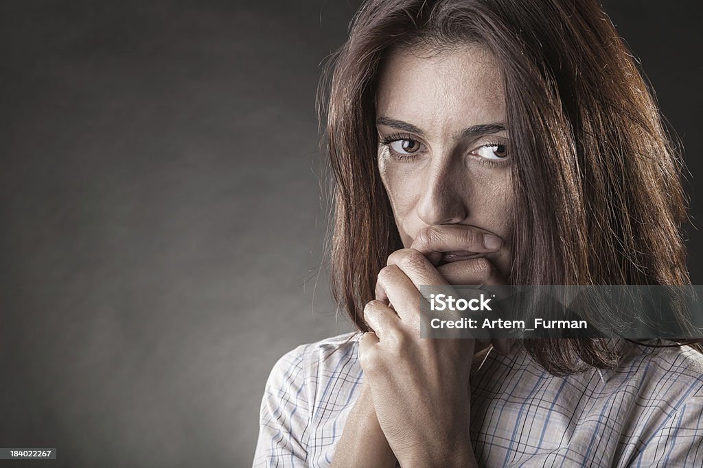 Crying woman Young crying woman on a dark background Adult Stock Photo