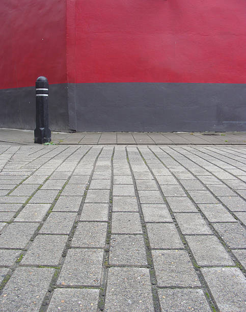 istock street view with corner,side-walk and bright red wall 184025225