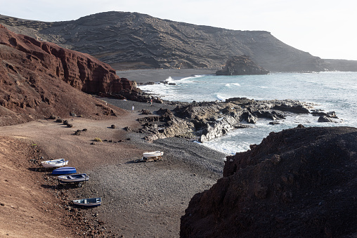 Small boats on the beach of El Golfo on the west coast of canary island Lanzarote