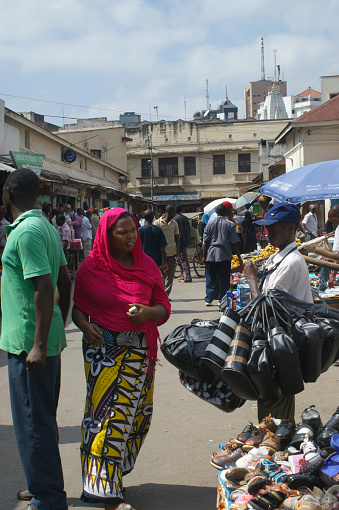 Mombasa market in the city center, Kenya. Market life in downtown Mombasa on a weekday. Crowds of buyers and sellers, stalls with fruits, vegetables, food products, clothes and various other goods. A place teeming with life and colors.