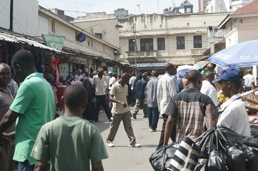 Mombasa market in the city center, Kenya. Market life in downtown Mombasa on a weekday. Crowds of buyers and sellers, stalls with fruits, vegetables, food products, clothes and various other goods. A place teeming with life and colors.