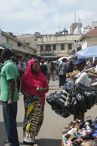 Mombasa market in the city center, Kenya. Market life in downtown Mombasa on a weekday. Crowds of buyers and sellers, stalls with fruits, vegetables, food products, clothes and various other goods. A place teeming with life and colors.