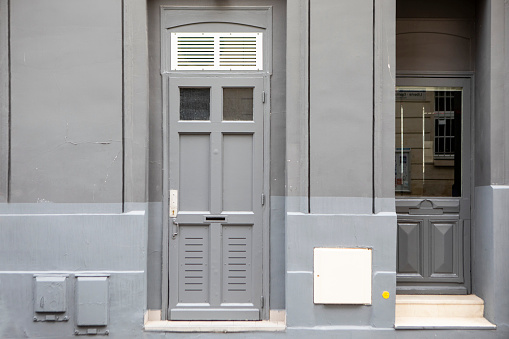 Two doors and a grey coloured exterior wall