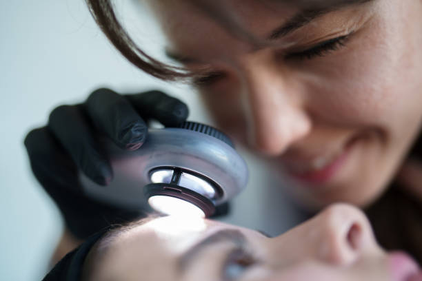 Dermatolog examining patient's skin