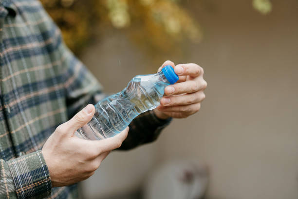 istock Man is holding a plastic bottle of water 1840351507