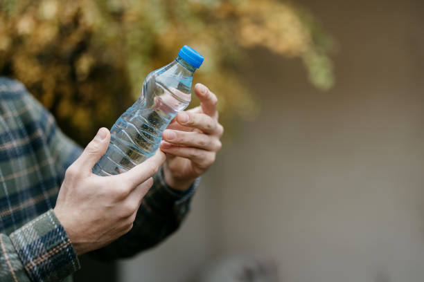 istock Man is holding a plastic bottle of water 1840351539