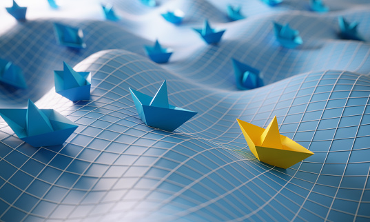 Blue colored paper boats and yellow colored one in the first place, can be used leadership/individuality concepts. (3d render)