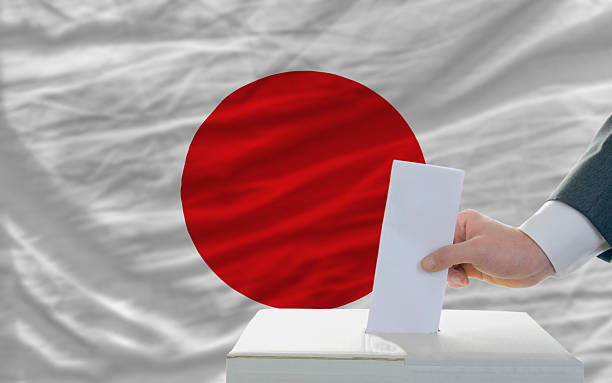 istock man voting on elections in japan front of flag 184037682