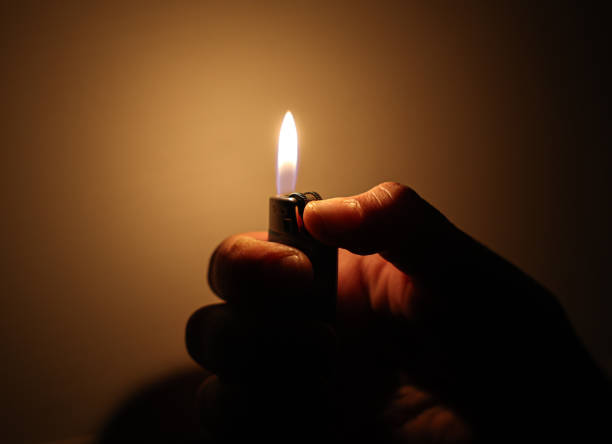 istock Person Holding a Lighter-lighting a lighter at night 1840382107