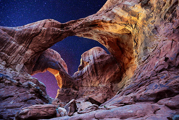 Double Arch-Stars Night exposure of Double Arch in Arches National Park Utah natural bridges national park photos stock pictures, royalty-free photos & images