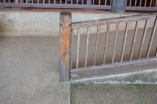 Concret ramp way with wooden handrail for support wheelchair disabled people.