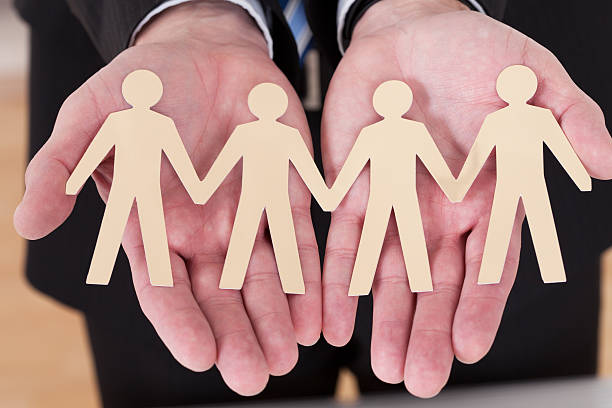 istock Male Hand Holding Human Figure Cutout 184040968