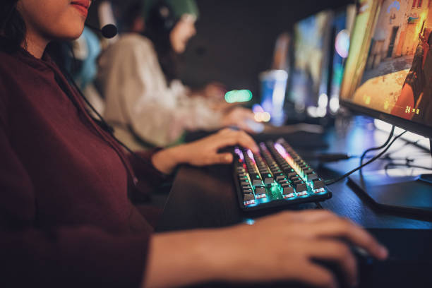 istock Young Asian Woman Gaming On Computer 1840410747
