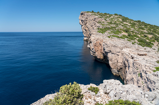 Rocky peninsula at one of Kornati islands. Sunny day, clear blue sky.