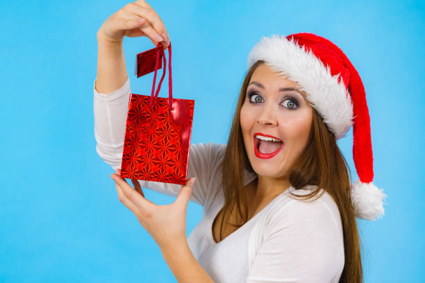 istock Happy Christmas woman holds gift bag 1840416021