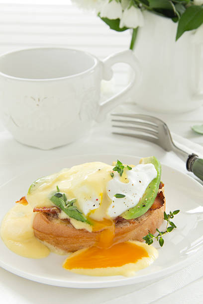 istock Breakfast. Poached egg with hollandaise sauce, bacon and avocado. 184042175