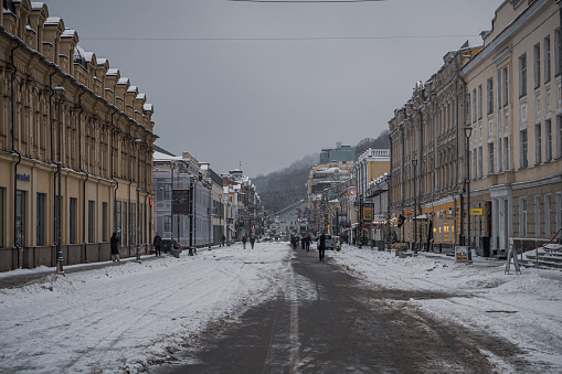 kyiv, ukraine - december 8, 2023: since the morning, the city is in the snow. people walking through the snowy central street