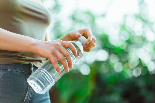 istock Bottle of water with green trees background 1840426466