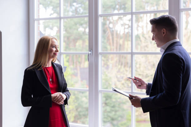 istock Real estate agent talks with woman about residence 1840427510