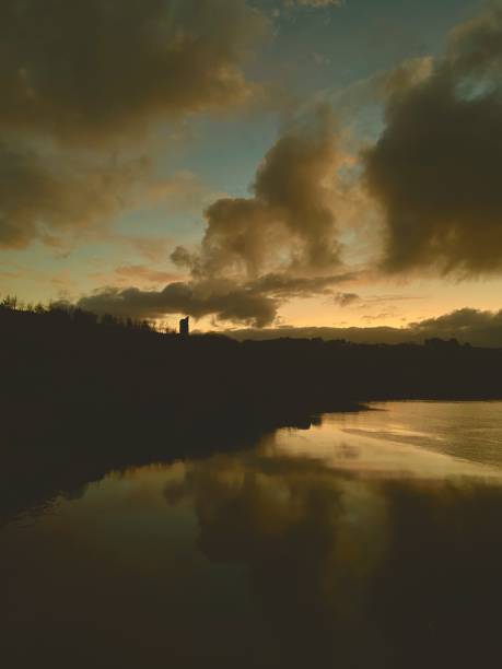 istock Dramatic Moody Sunset And Castle Over Water 1840429466
